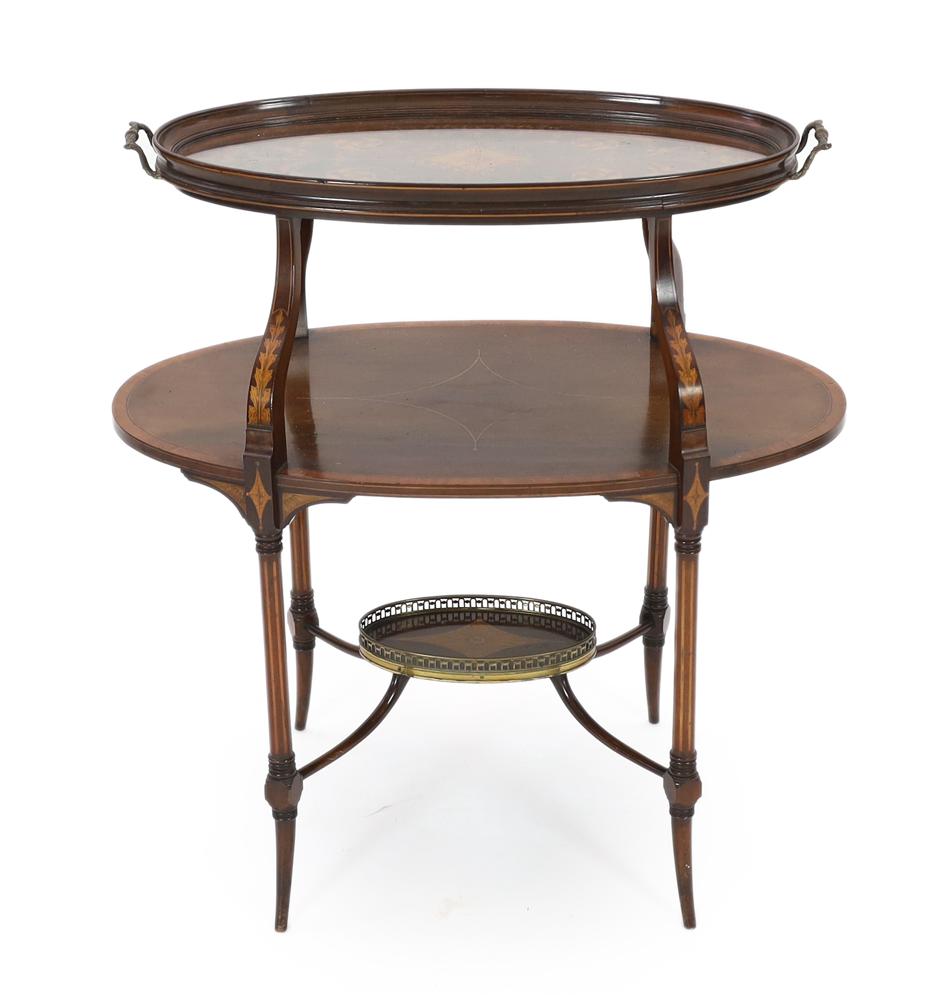 In the manner of Edwards and Roberts, an Edwardian marquetry inlaid mahogany tray top etagere, of oval form, with glass tray top over a marquetry scrollwork panel, mid tier and brass galleried understage, 82cm wide, 47cm